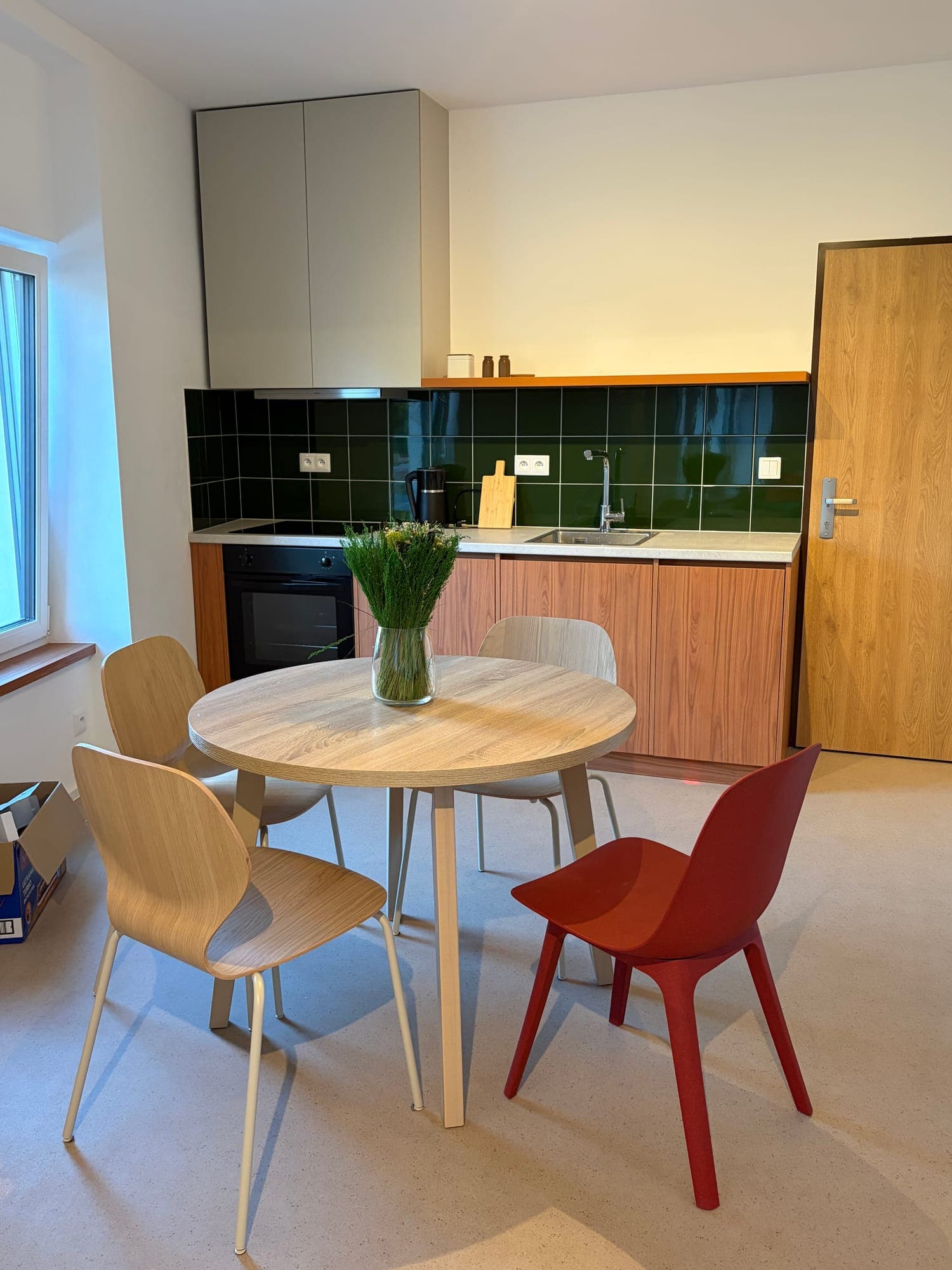 Kitchen with green tiles and dining table