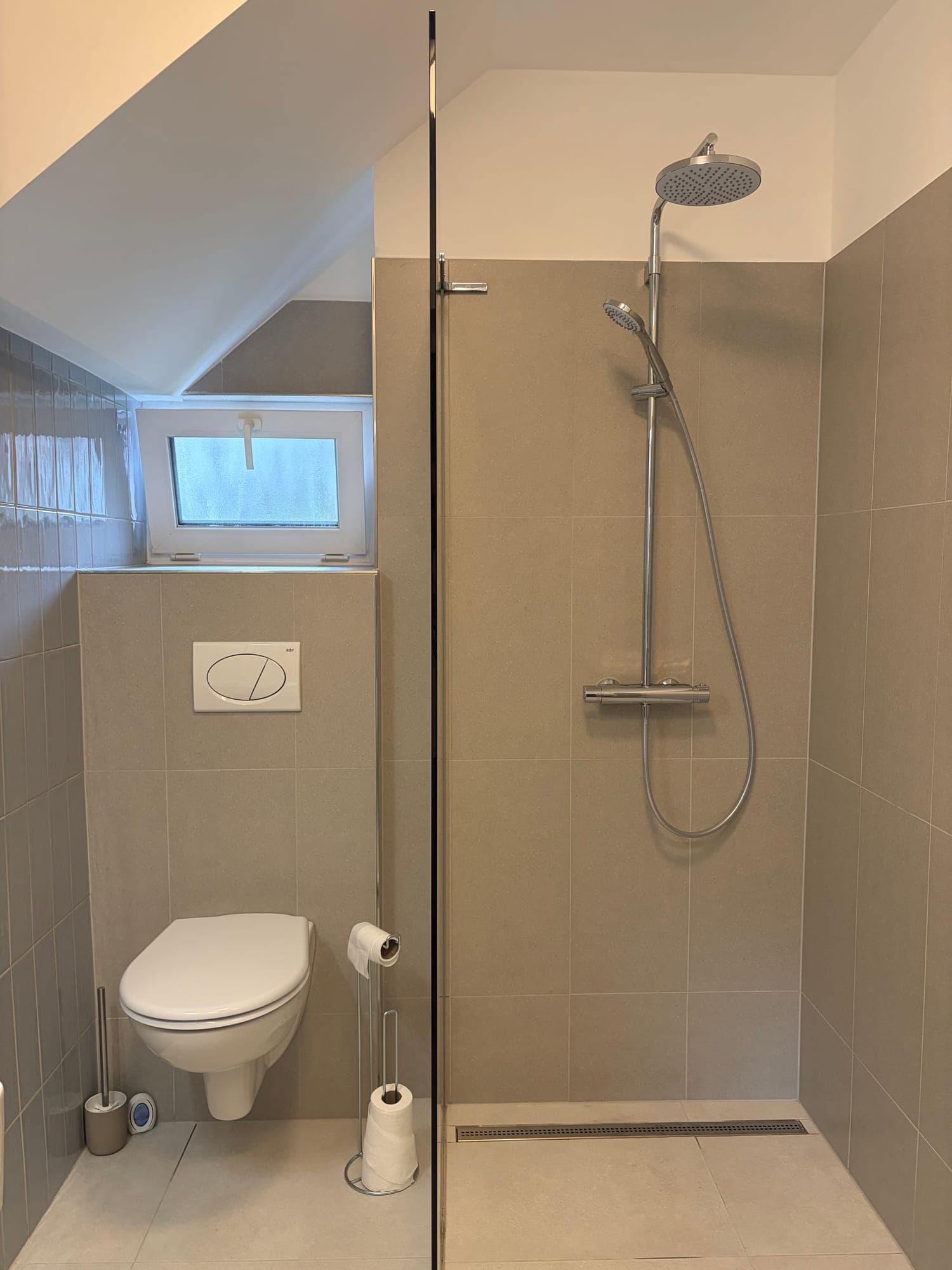 Bathroom with walk-in shower and window